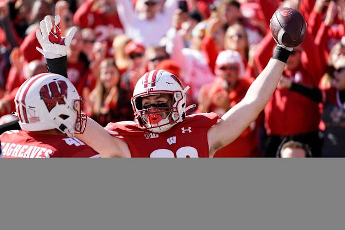 Oct 7, 2023; Madison, Wisconsin, USA; Wisconsin Badgers tight end Tucker Ashcraft (38) celebrates with wide receiver Skyler Bell (11) after scoring a touchdown during the fourth quarter against the Rutgers Scarlet Knights at Camp Randall Stadium. Mandatory Credit: Jeff Hanisch-USA TODAY Sports